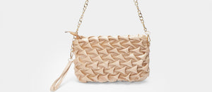 Beige woven handbag with a chain strap on a light gray background
